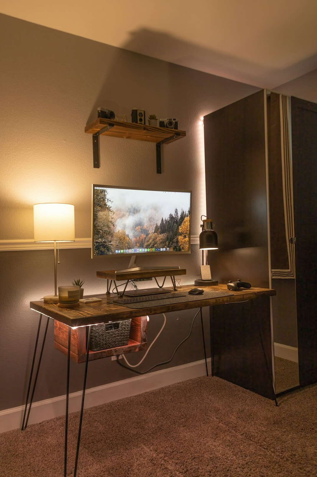 Modern video editing studio with monitors, camera gear and warm ambient lighting