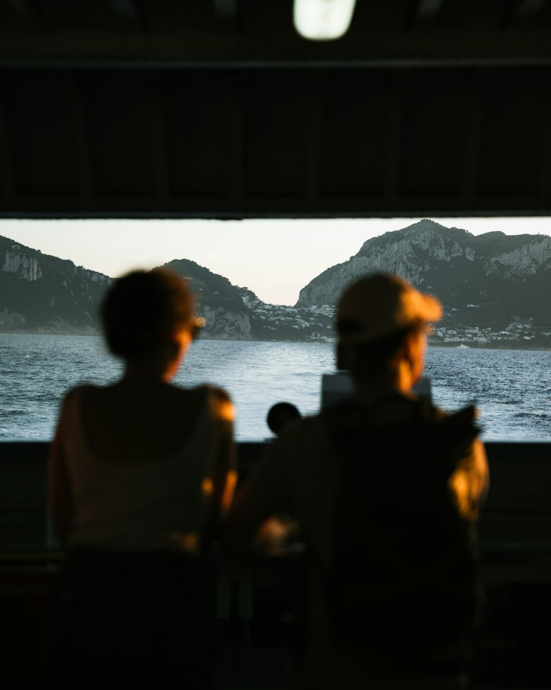 Two French-Swiss creatives reviewing colour grading on a monitor in an editing studio